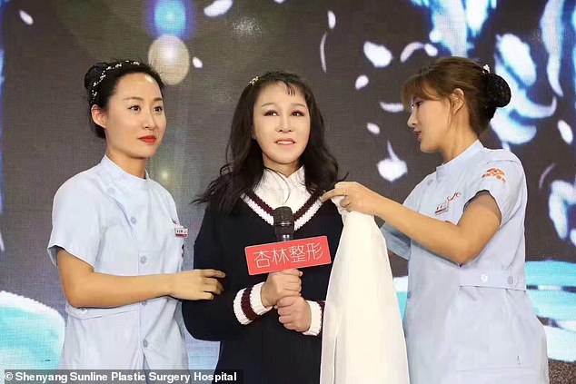 Xiao Feng greets the press after two nurses took off a veil over her face in Shenyang today
