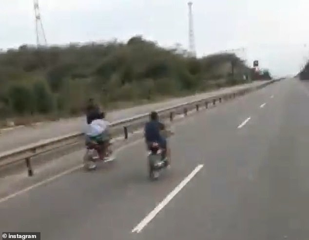 A passenger films the two participants of an illegal motorcycle race in the Dominican Republic. The vehicle he was traveling in struck a man who was standing next to the highway media guardrail, killing him on the spot