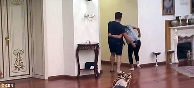 The 24-year-old is marched away from the table of contestants in a headlock by her husband