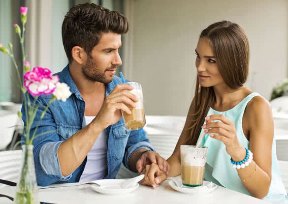 Young couple talking and drinking coffee
